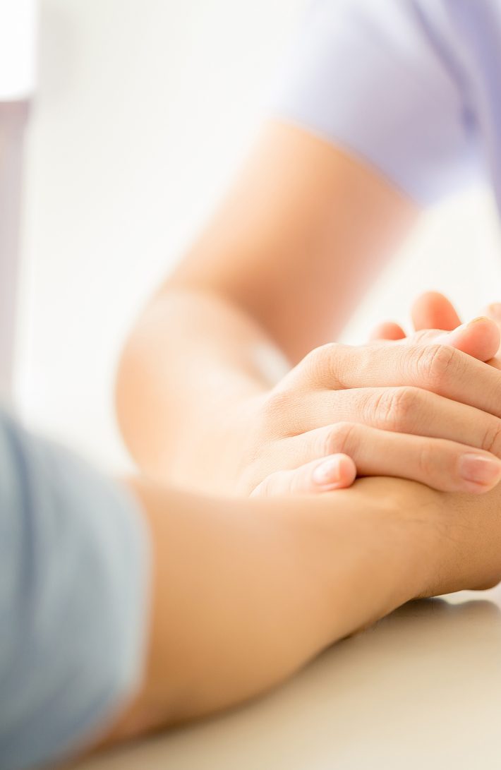 female psychologist consulting patient at the desk in hospital.